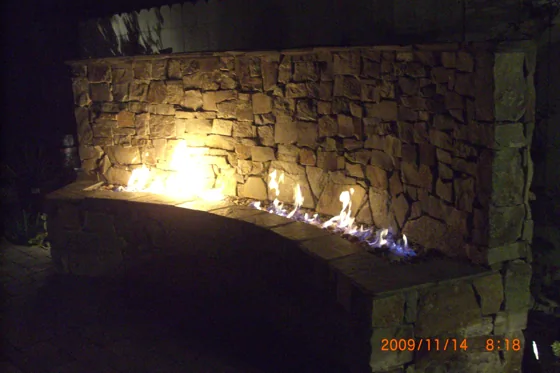 Illuminated stone wall and water feature