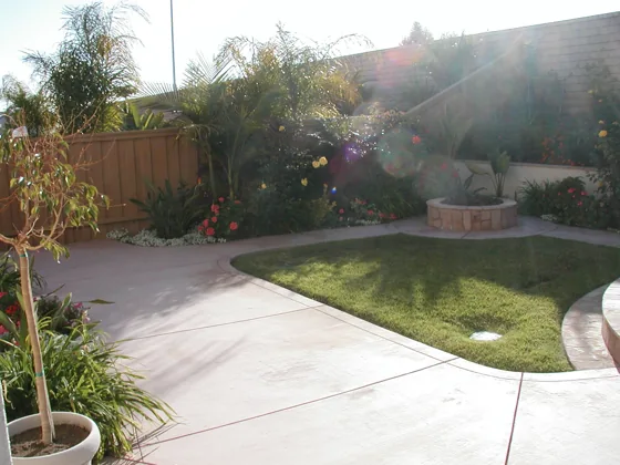Curved concrete pathway and planting beds
