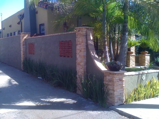 Stone wall and outdoor storage structure